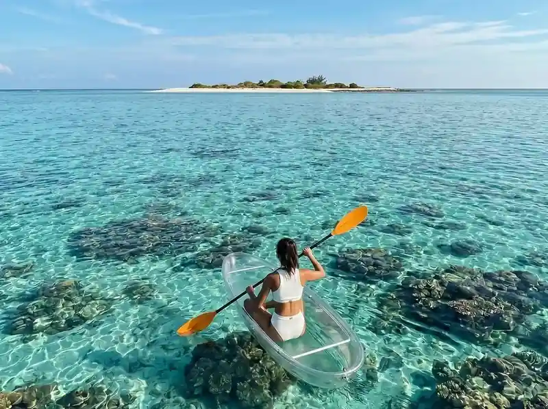 Exploring crystal clear waters by kayak near Turtle Seaweed Resort in the Celebes Sea